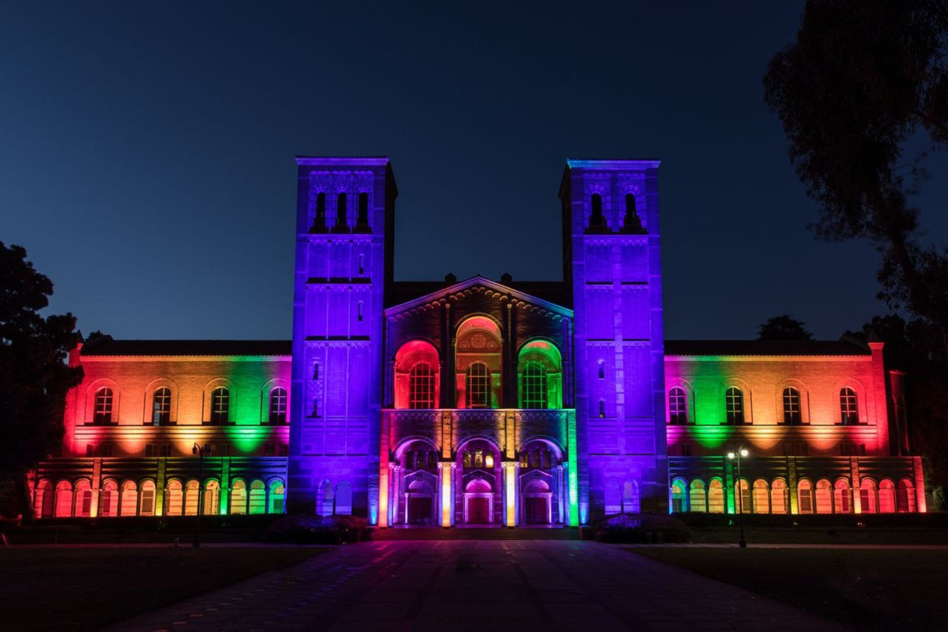 Photo of iconic Royce Hall with rainbow lights.