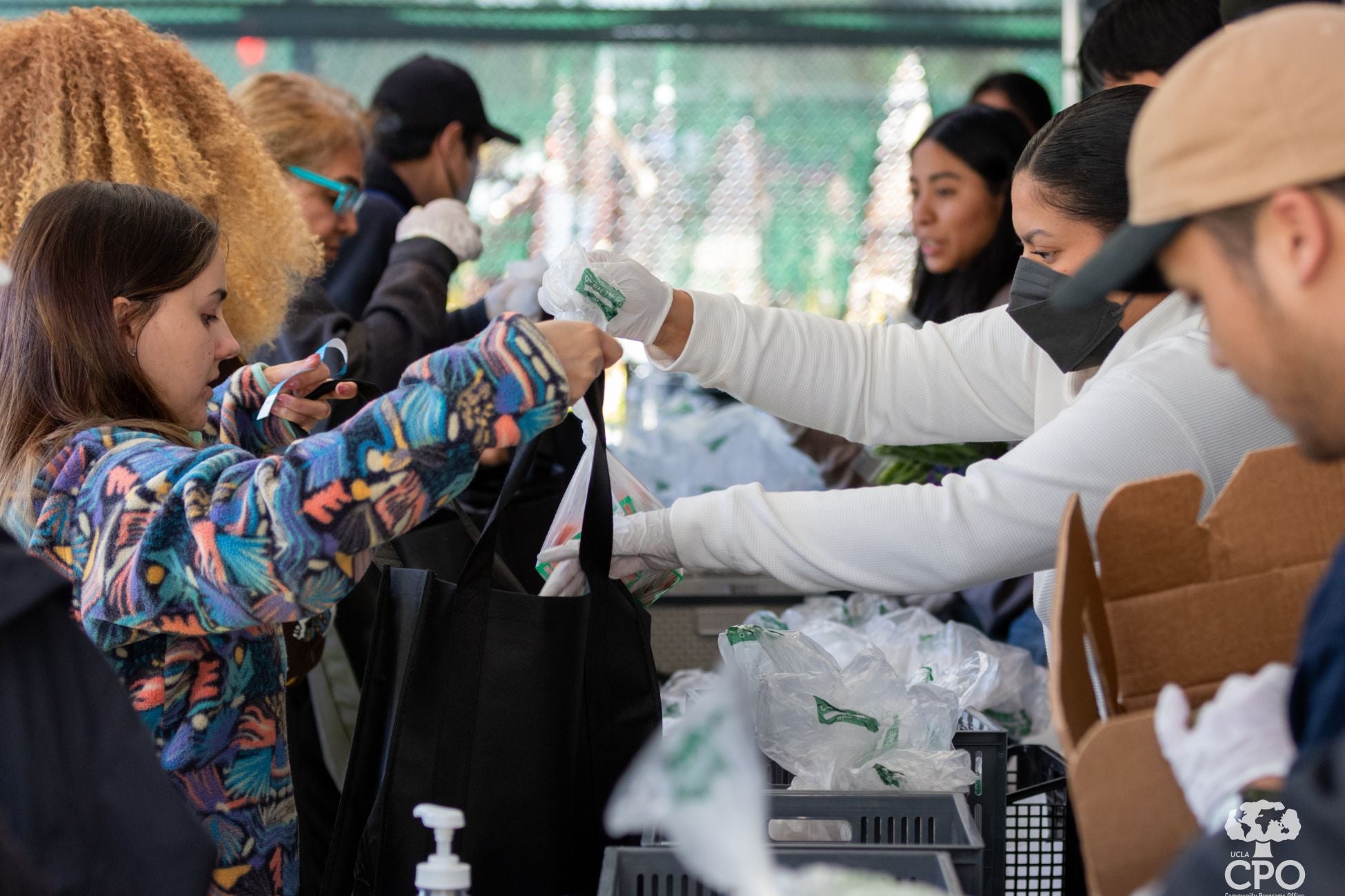 Individuals receiving supplies and goods from community members