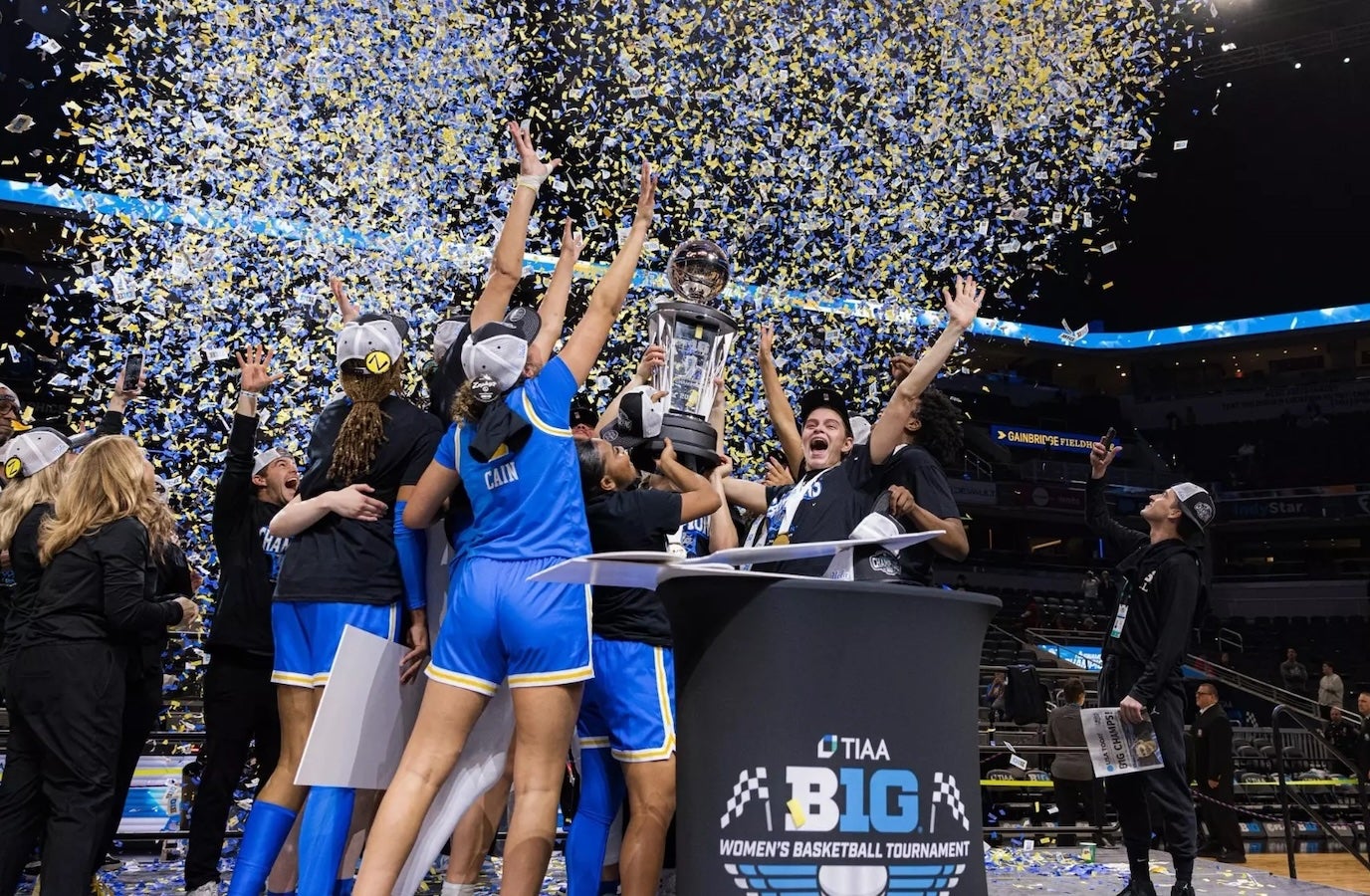  Women&#039;s basketball team joyfully celebrating their championship victory with smiles and team spirit.