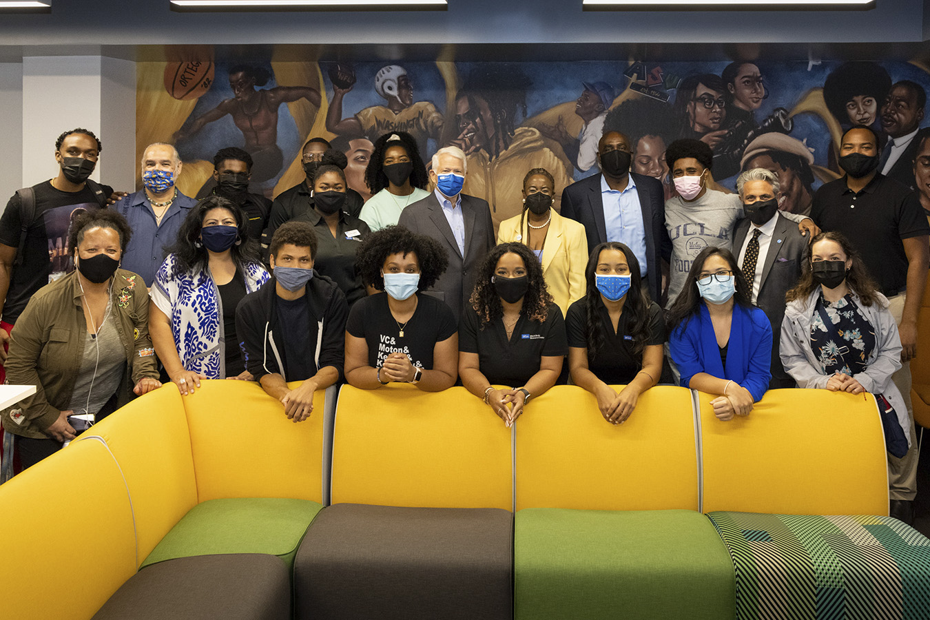 A group of individuals pose at the opening of new center.