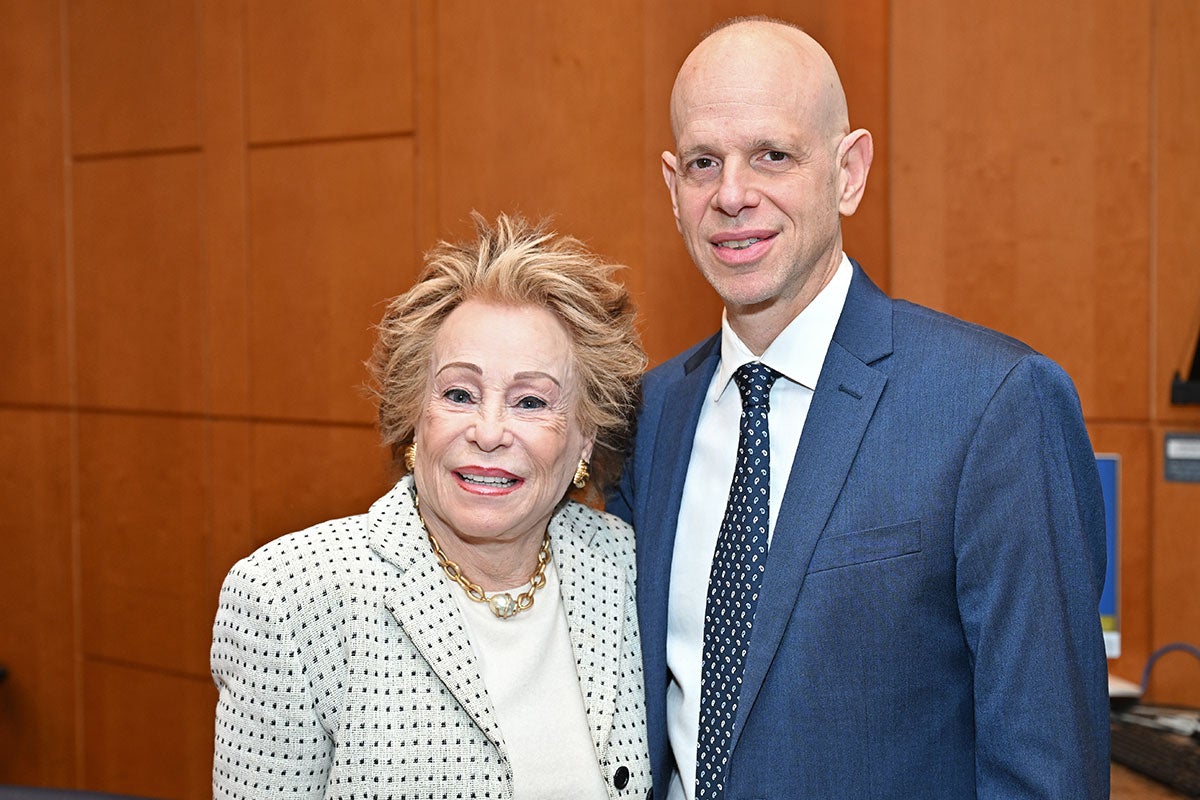 From left: Joyce Brandman in white and black next to John Belperio in suit and tie