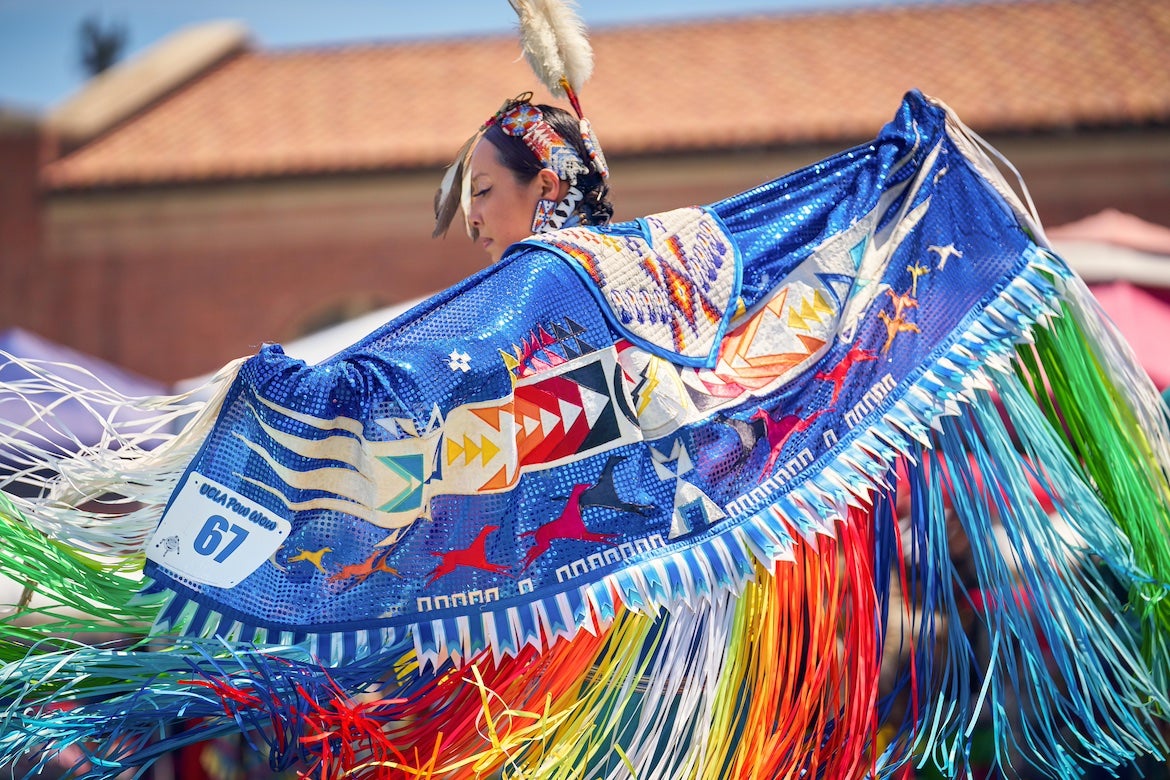 A portrait of a dancer in Native dress taken at the UCLA Pow Wow in May 2023. 