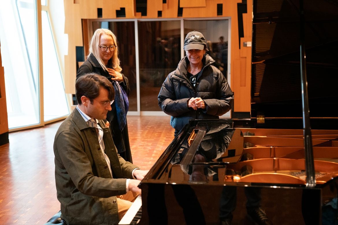 David Kaplan plays the Sinatra family piano as Eileen Strempel, left, and Tina Sinatra watch